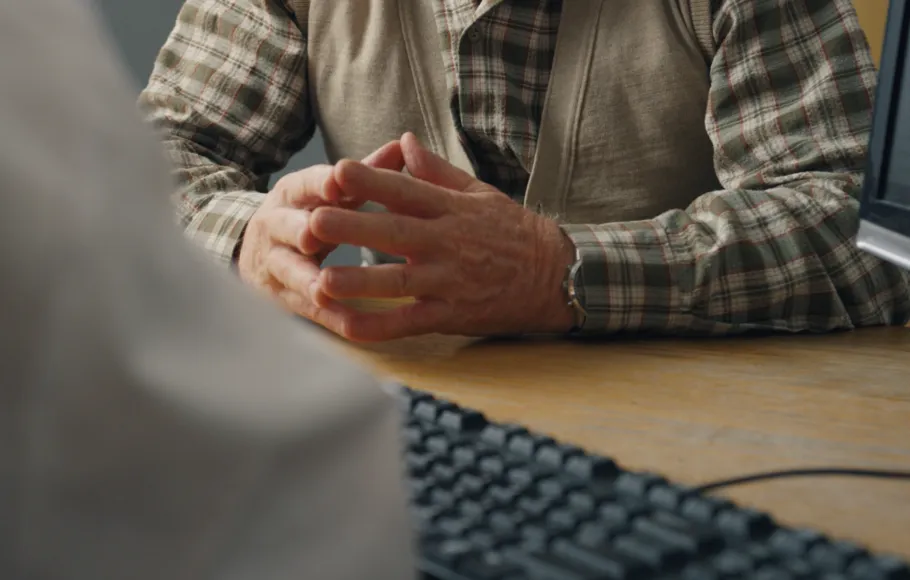 Mans hands clasped together