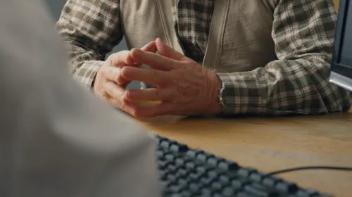 Mans hands clasped together